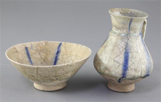 A Kashan pottery ewer and a similar reticulated bowl, 12th/13th century, Seljuk, height 14cm and diameter 16cm, both with restoration